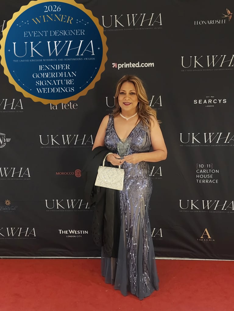 Woman holding award at UKWZA event on red carpet, wearing gray beaded dress